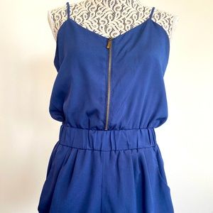 Navy blue romper with gathered sides and cinched waste